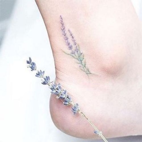 Fine line lavender tattoo located on the inner forearm.
