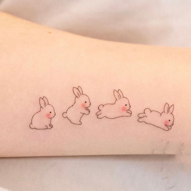 Fine line rabbit tattoo located on the wrist.