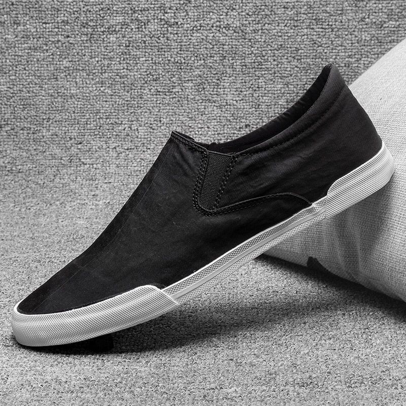 black canvas slip ons