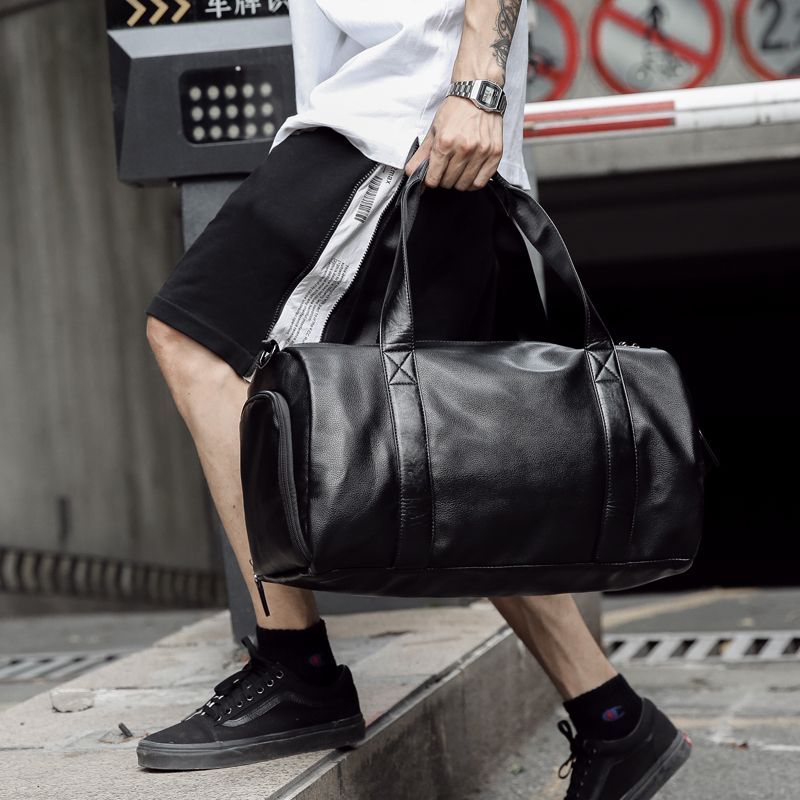 black faux leather duffle bag