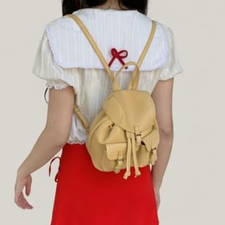 Basaran-Faux Leather Buckled Strap Flap Backpack